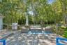 Wooden terrace featuring a grill and an outdoor hangout area