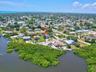 Aerial perspective of the surrounding neighborhood and nearby water features.