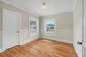 A charming upstairs bedroom offers natural light, classic trim, and the versatility to fit a variety of needs.