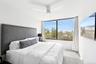 Bedroom with ceiling fan and carpet