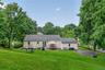 Private backyard features a spacious paved area offering plenty of flexibility for a basketball court, recreation area, or other outdoor activities.