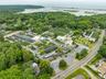 Aerial view of property and surrounding area featuring a nearby body of water