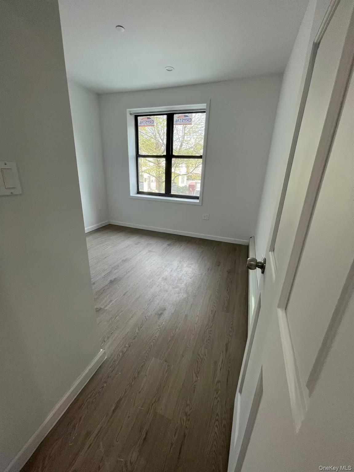 Spare room with wood finished floors and baseboards