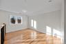 Empty room with vaulted ceiling and light wood-type flooring