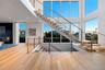 Stairs featuring wood finished floors, a high ceiling, and recessed lighting