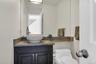 Half bathroom with toilet and vanity