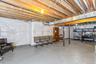 Unfinished basement featuring  white wall insulation