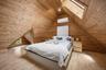 Finished Attic – Beautifully crafted finished attic featuring rich wood-paneled walls and vaulted ceilings, skylights, and a bright, open layout. This
