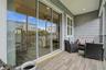 Spacious covered terrace with sliding glass doors, perfect for relaxing or entertaining right off the living area.
