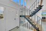 Entrance foyer with stairway and a high ceiling