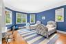 Bedroom featuring wood finished floors and multiple windows