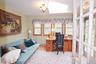 Room featuring multiple windows with wood trim, a skylight, and light-toned walls