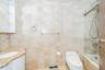 Full bathroom with tile walls, vanity, and tiled shower / bath combo