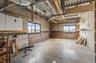 Below grade area with concrete block wall and healthy amount of natural light