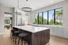 Oversized windows frame beautiful views of the lush tropical landscaping.