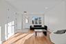 Living area featuring light wood-style flooring and recessed lighting