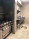 Kitchen with tasteful backsplash, tile walls, and light tile patterned floors