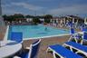 Community pool with a patio