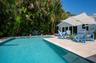 Imagine taking a dip in this refreshing pool in this private tropical oasis