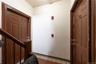 Hall with light tile patterned flooring and baseboards