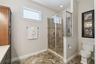 The same bathroom with a walk in shower.