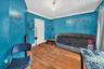 Bedroom with crown molding and wood finished floors