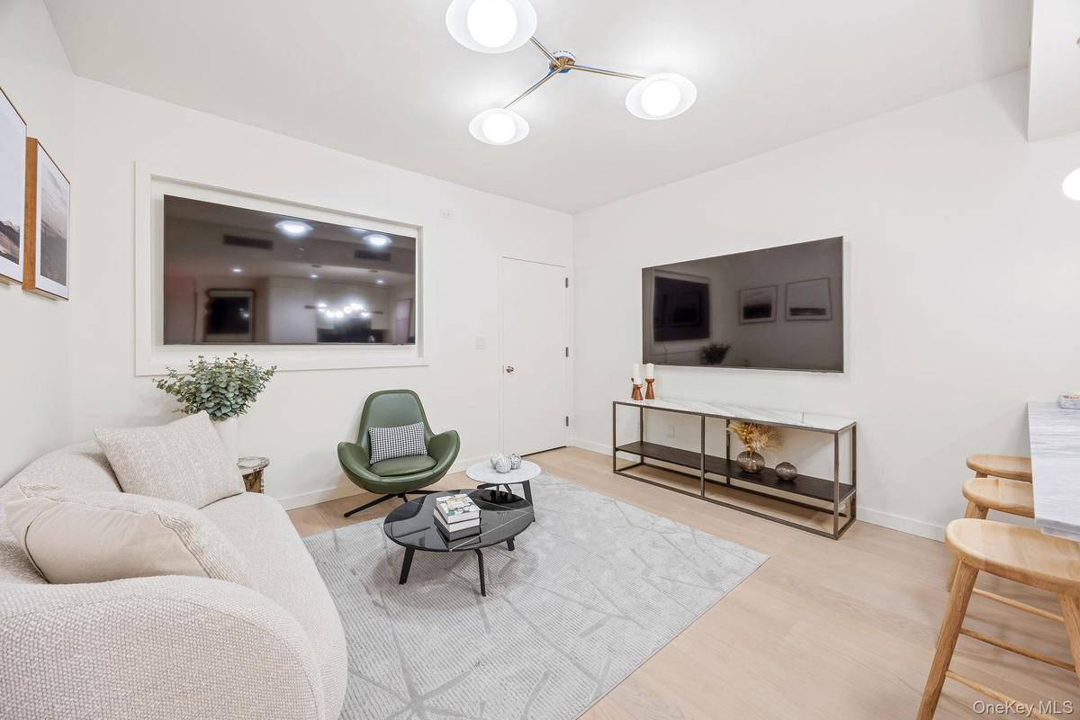 Living area with wood finished floors and baseboards