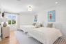 Bedroom with wood walls, light wood-style floors, and recessed lighting