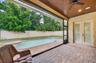 Private lanai with tongue & groove ceiling and remote screens