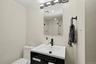 Sleek glass shower doors, designer lighting, and an elegant statement mirror, creating a polished and serene space to begin and end the day.