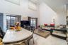 Dining area featuring a towering ceiling and tile patterned floors
