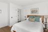 Bedroom featuring dark wood-type flooring and baseboards