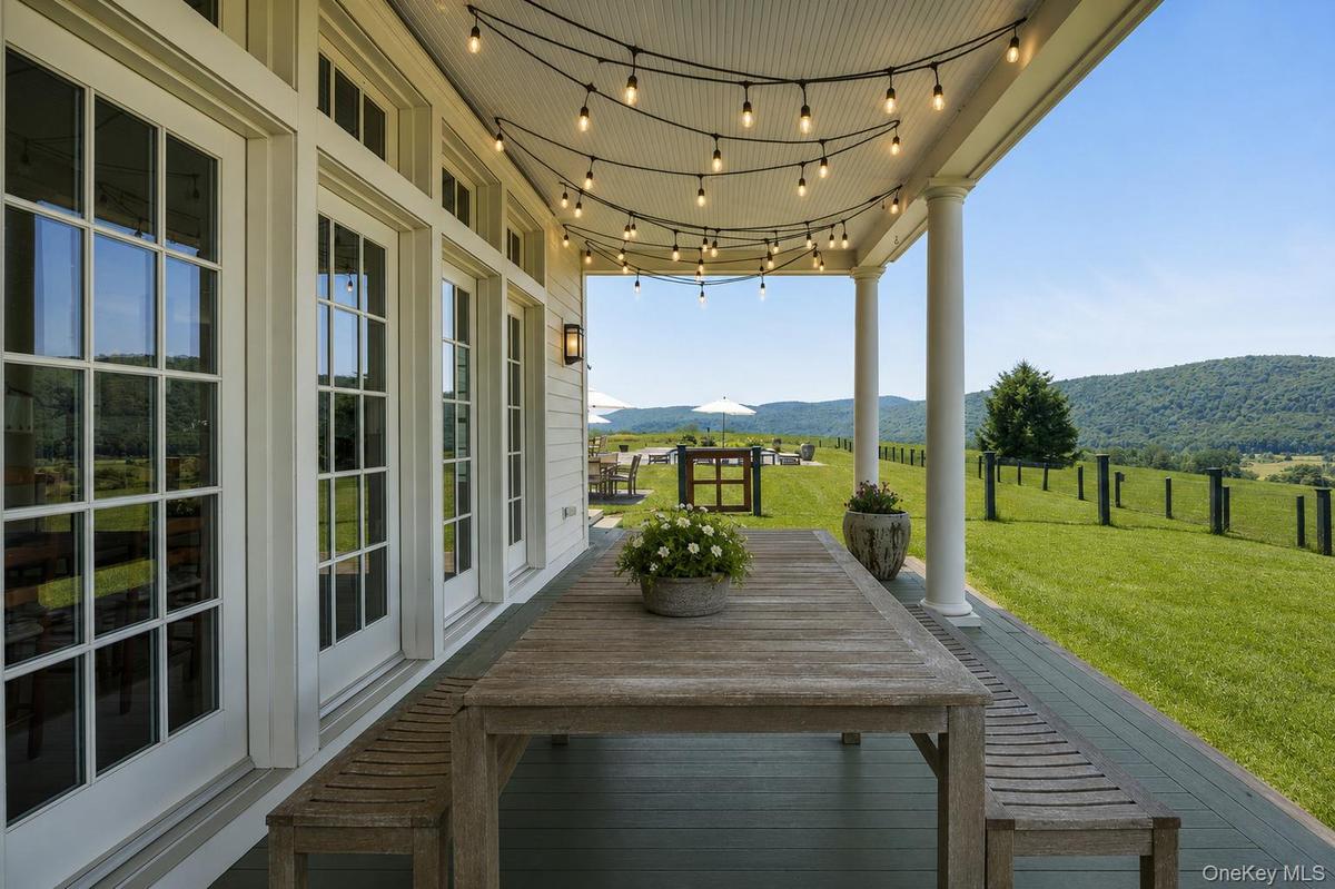 A Stunning West-Facing Front Porch is the Perfect Place to Enjoy Meals or Drinks to Watch the Sun Set.