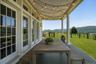 A Stunning West-Facing Front Porch is the Perfect Place to Enjoy Meals or Drinks to Watch the Sun Set.