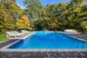 View of swimming pool with a patio area and a pool with connected hot tub