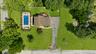 Aerial view showcasing a virtually staged large pool and patio.  Massive yard can be a new owners playground and sactuary!