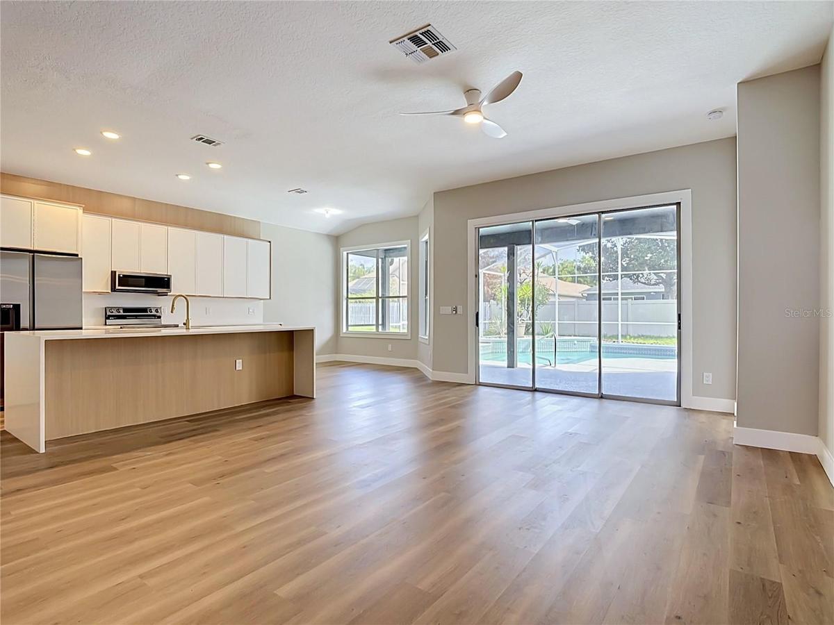 bright open-concept layout with new vinyl flooring, a fully renovated kitchen