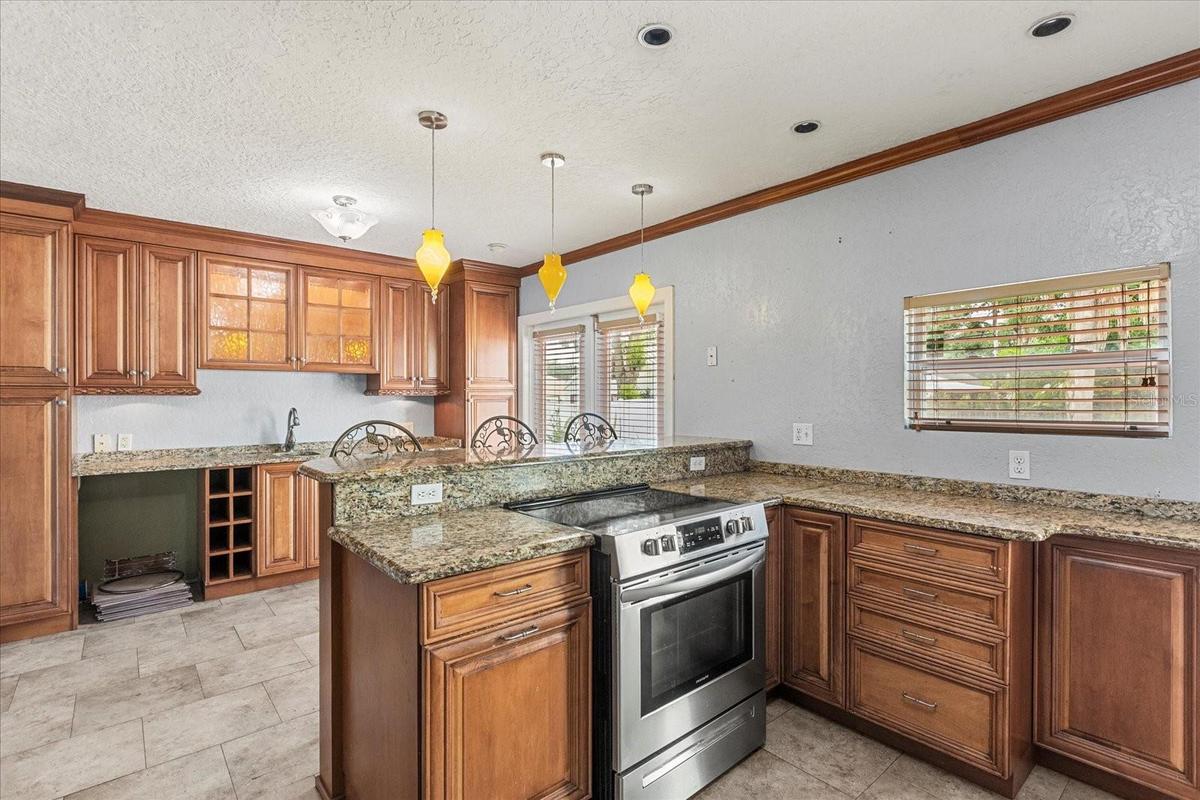Kitchen w/Breakfast Counter and Custom Cabinetry
