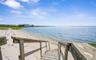 View of dock with a water view and a view of the beach