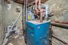 Utility room featuring a heating unit and water heater