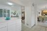 The closet underneath the clock is a very generous size pantry area. All of your supplies can be neatly packed away.