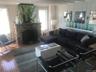 Living room with plenty of natural light, hardwood / wood-style floors, a decorative wall, and a fireplace