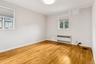 Spare room with light wood finished floors, radiator, and ornamental molding