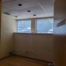 Empty room with visible vents, wood finished floors, and a paneled ceiling