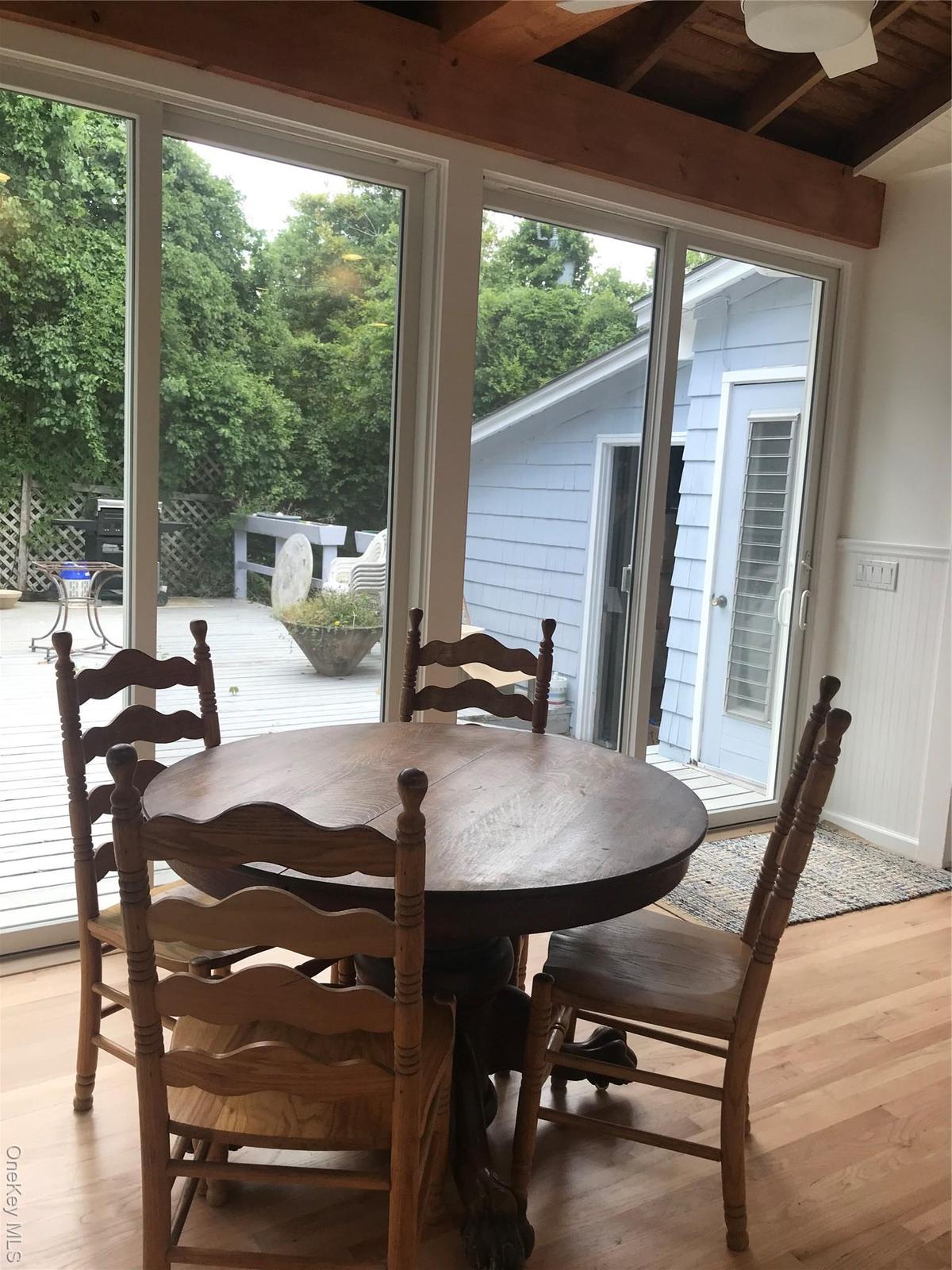Dining area with a wainscoted wall and light wood-style flooring
