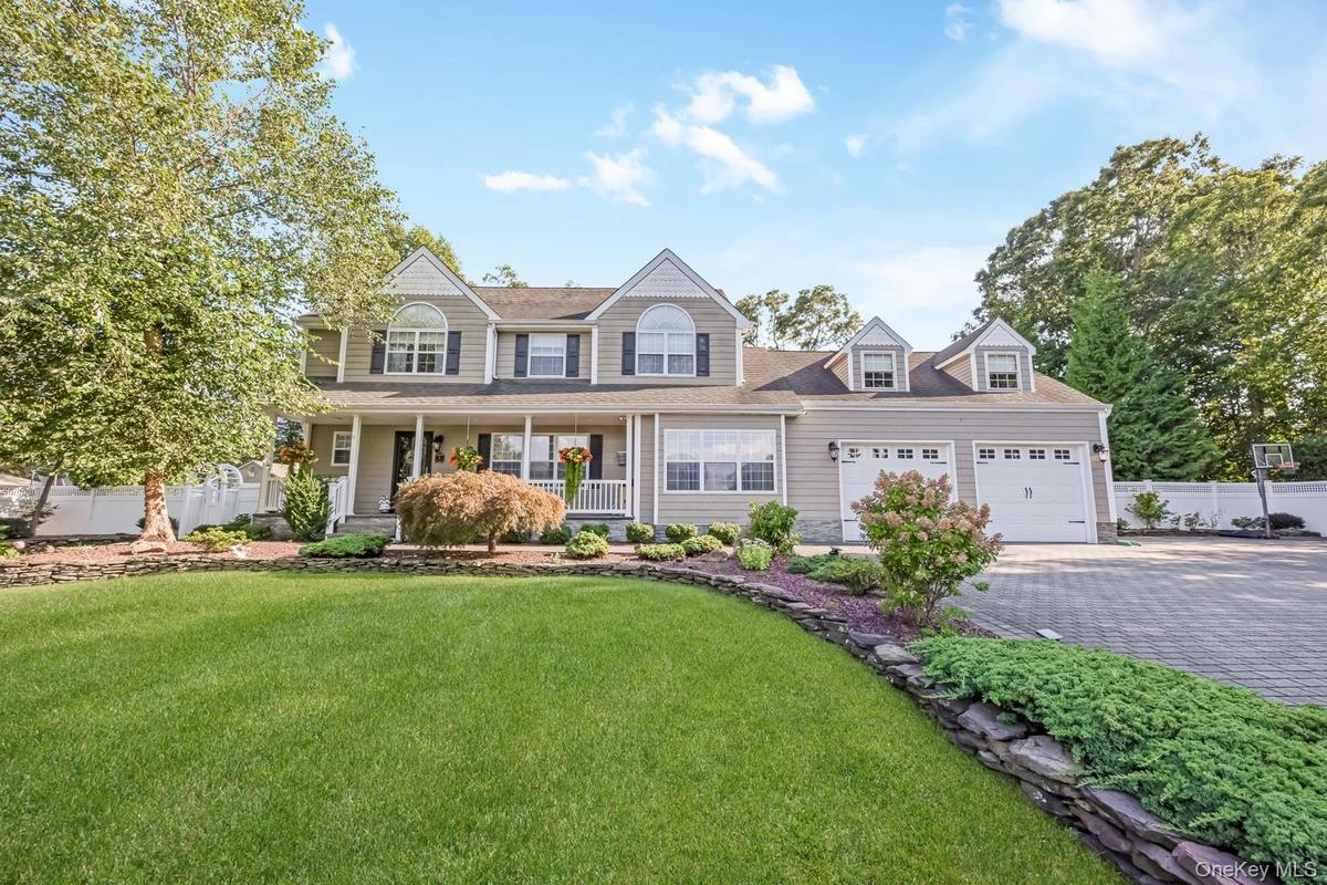 Two-story residence with a covered front porch and dormer windows