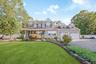 Two-story residence with a covered front porch and dormer windows