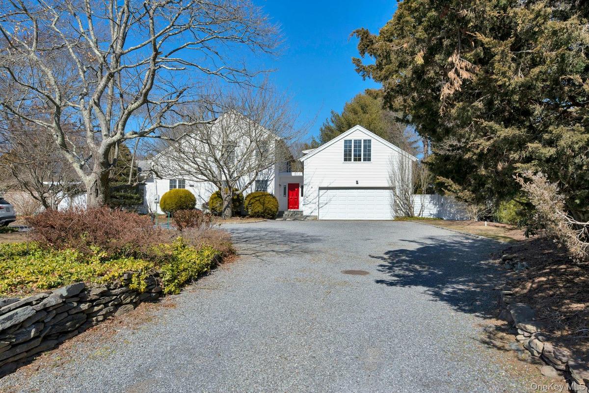 Exterior with circular driveway and front yard with 2 car garage