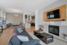 Beautiful gas fireplace surrounded by Caesarstone and complemented by a handsome tv mount