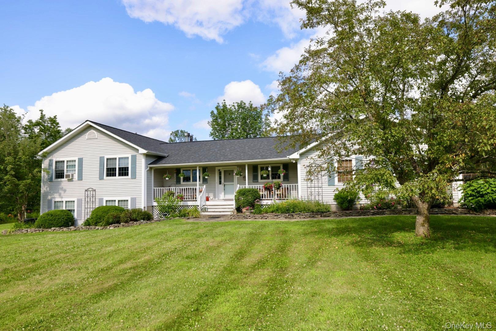 Home with a porch and a front yard